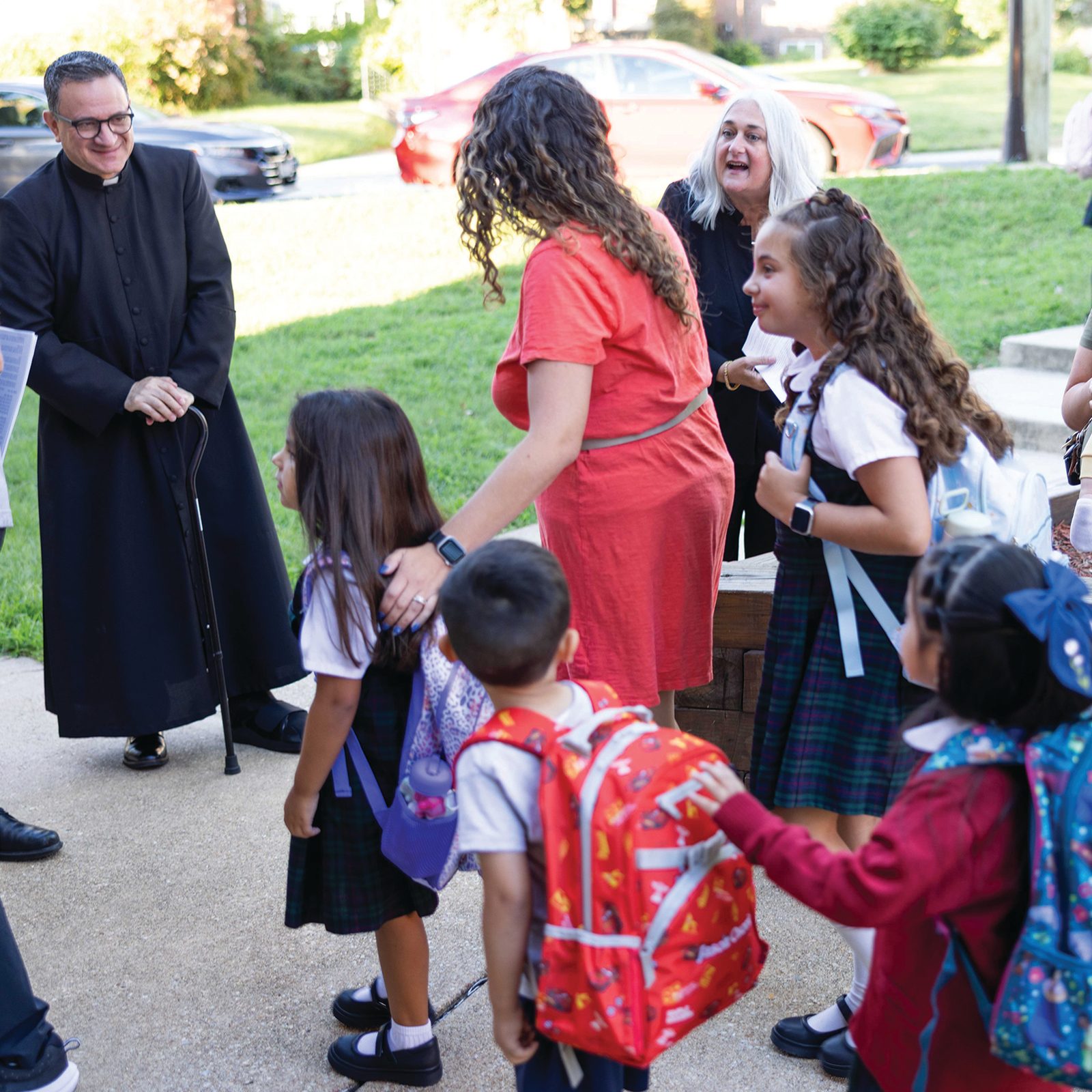 Father Alejandro Diaz, the pastor of St. Ambrose Parish in Cheverly, Maryland and Kelly Branaman, the Secretary for Catholic Schools and Superintendent of Schools for the Roman Catholic Archdiocese of Washington, greet St. Ambrose School students and their families on the first day of classes, Aug. 26, 2025. (Catholic Standard photo by Andrew Biraj)