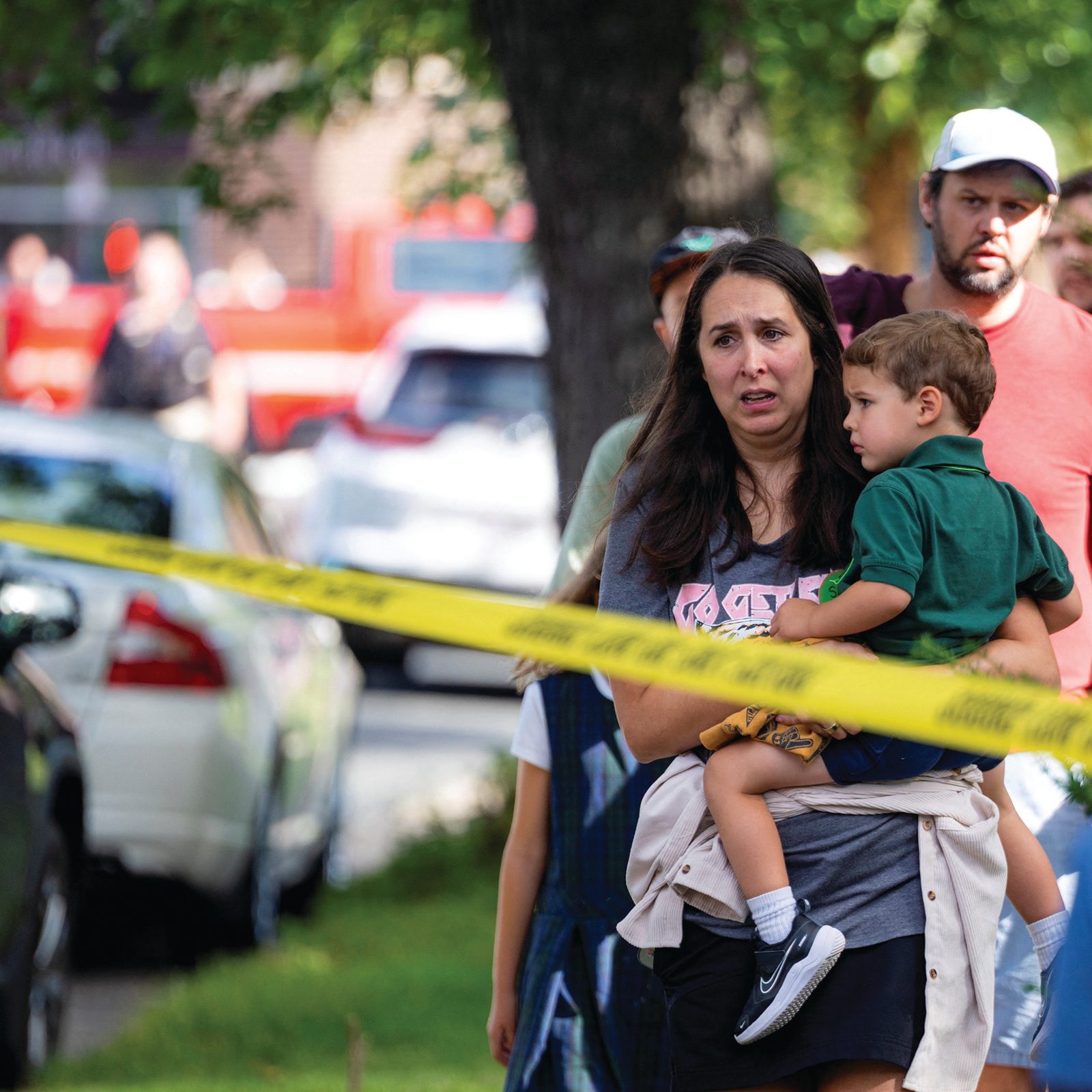 Above and below, families and loved ones walk outside the police barricades following a shooting at Annunciation Catholic School in Minneapolis Aug. 27, 2025. The Richfield Police Department is reporting there are up to 20 victims; two children and the suspected shooter are dead. (OSV News photos/Ben Brewer, Reuters)