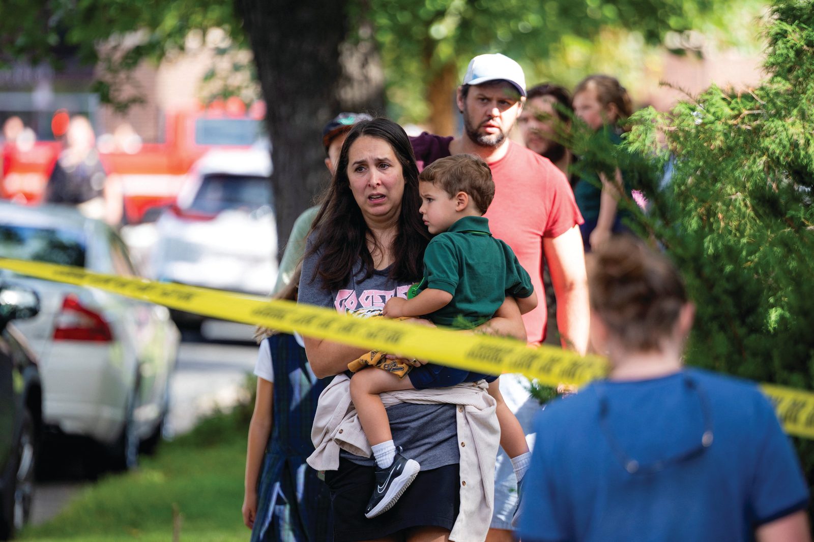 Above and below, families and loved ones walk outside the police barricades following a shooting at Annunciation Catholic School in Minneapolis Aug. 27, 2025. The Richfield Police Department is reporting there are up to 20 victims; two children and the suspected shooter are dead. (OSV News photos/Ben Brewer, Reuters)