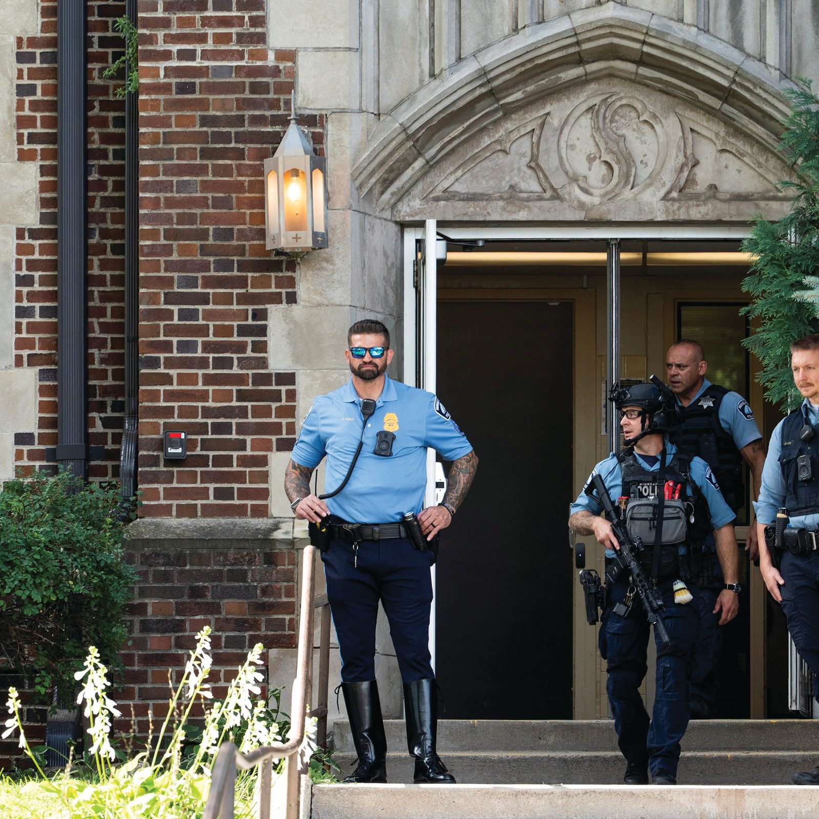 Following a shooting, first responders stand at the entrance to Annunciation Catholic School in Minneapolis Aug. 27, 2025. A shooter opened fire with a rifle through the windows of a the school church and struck children celebrating Mass during the first week of school, killing two and wounding 17 people in an act of violence the police chief called “absolutely incomprehensible.” (OSV News photo/Tim Evans, Reuters)