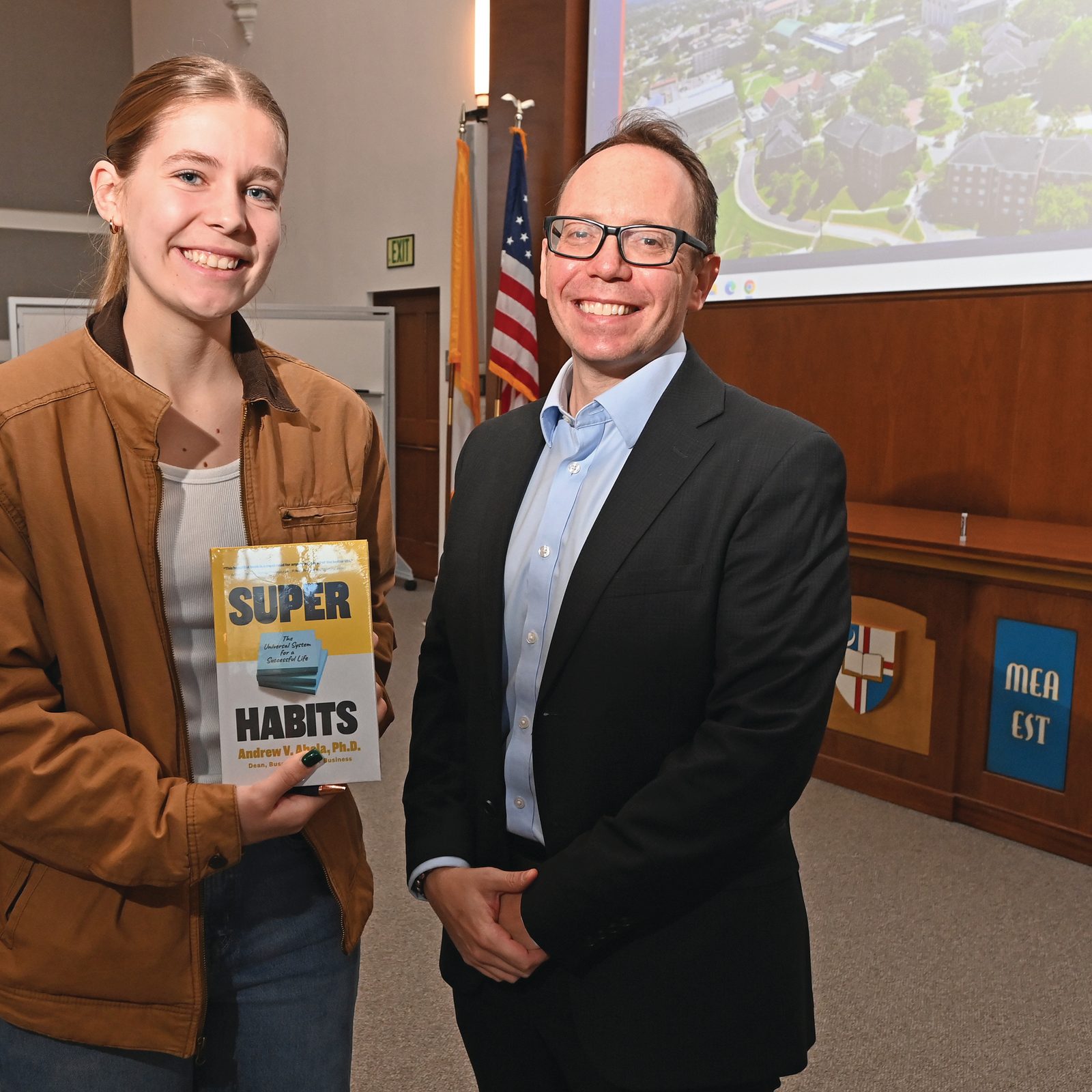 Anthony Cannizzaro, associate dean of faculty and academic affairs, (right) awards the 2024 Deans' Award to Karolina Bonn (left) and Karo's Kakes for her outstanding presentation at the 2024