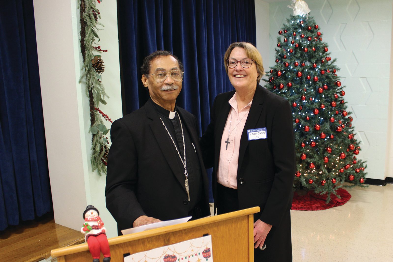 Washington Auxiliary Bishop Roy Campbell Jr. and Sister Nancy Downing of the Congregation of Notre Dame who is St. Ann’s CEO, pose for a picture during the Dec. 8 open house at St. Ann’s Center for Children, Youth and Families. (Photo courtesy of St. Ann’s Center for Children, Youth and Families)