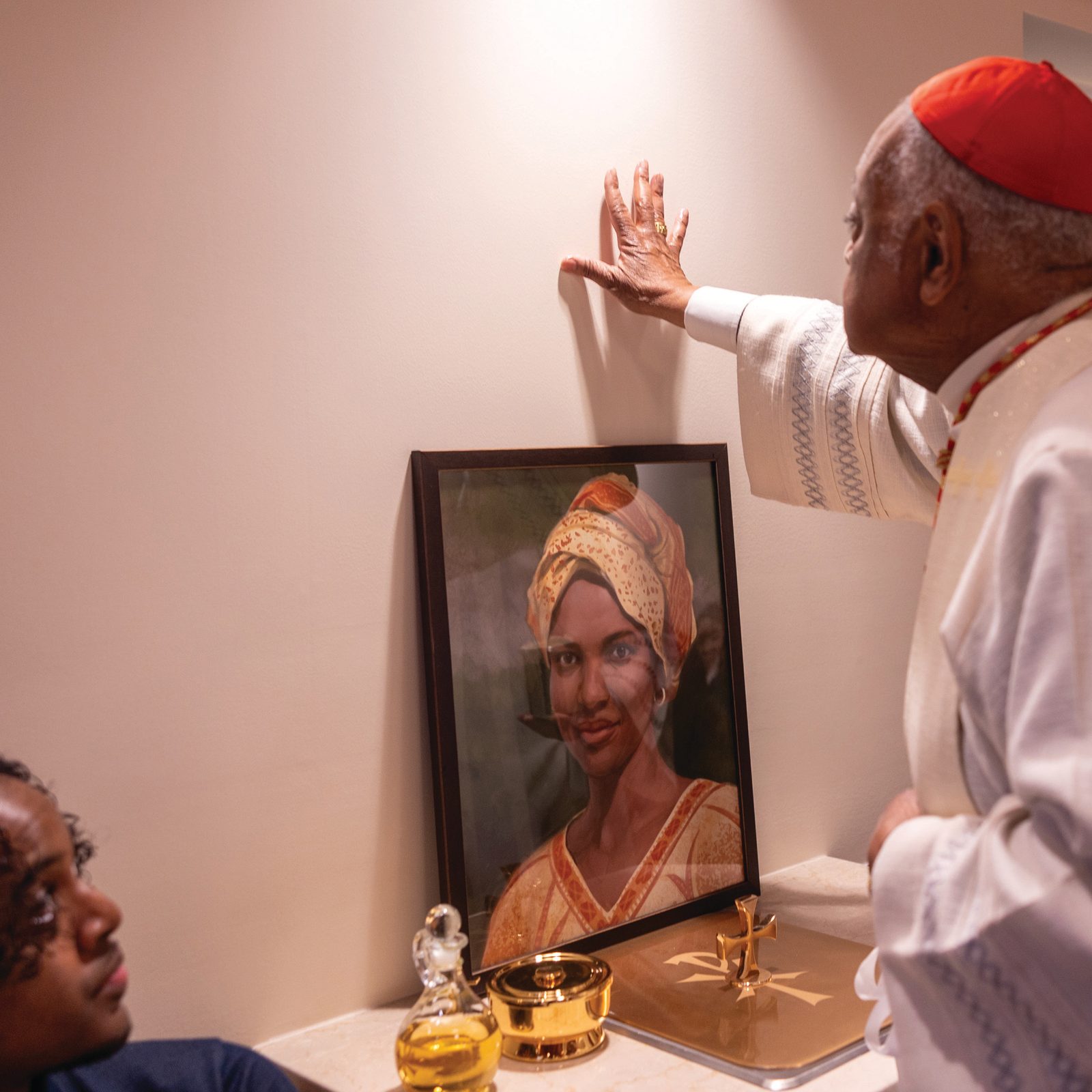 Cardinal Wilton Gregory, apostolic administrator of The Roman Catholic Archdiocese of Washington, blesses a chapel wall during the dedication of the new chapel at the Sister Thea Bowman Catholic Student Center at Howard University on Feb. 27, 2025. A portrait of Sister Thea Bowman, for whom the center is named, rests on a table in the chapel. (Catholic Standard photo by Mihoko Owada)