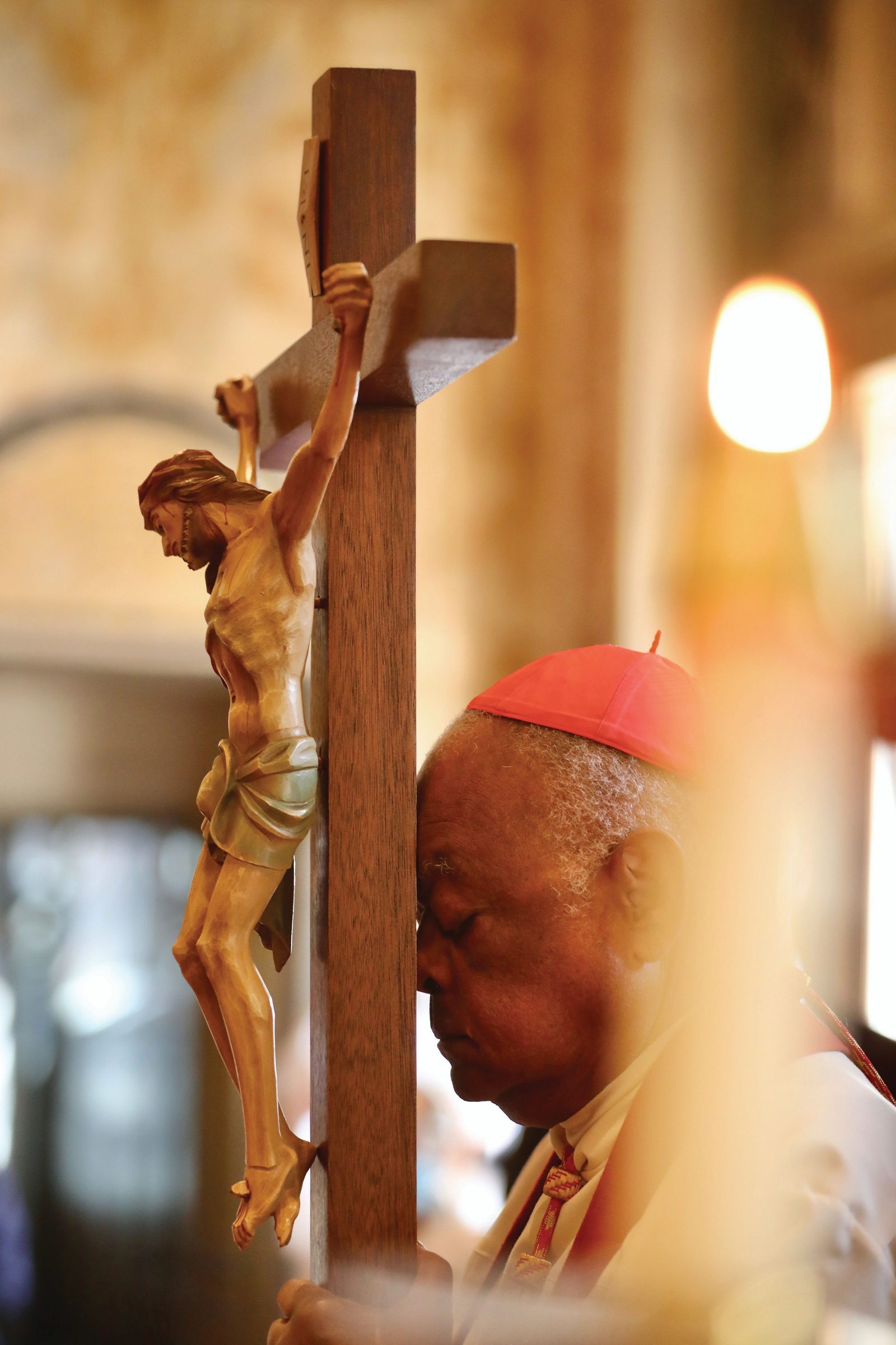 Washington Cardinal Wilton Gregory prays as he elevates the cross during the Good Friday Celebration of the Passion of the Lord on April 15, 2022 at the Cathedral of St. Matthew the Apostle. In his homily at that liturgy, he spoke out against the death penalty. (Catholic Standard photo by Andrew Biraj)