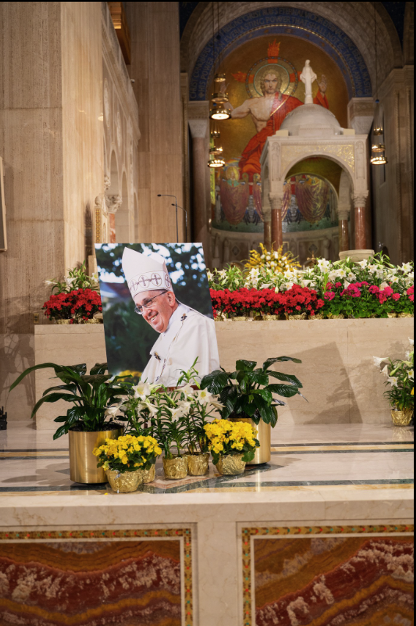 An image of Pope Francis surrounded by flowers adorns the altar at the Basilica of the National Shrine of the Immaculate Conception. An April 26 Mass offered there gave thanks for the life and ministry of the late pope. (CS photo by Nicole Olea)