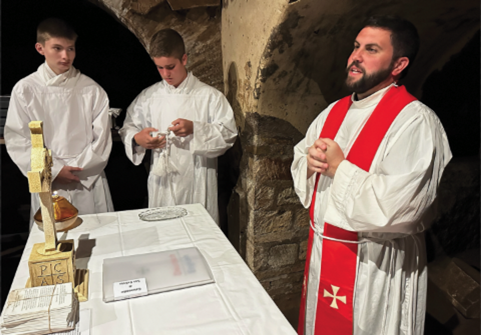 Father Thom Robertson, then parochial vicar of Little Flower Parish in Bethesda, Maryland, now priest-secretary to Cardinal Robert McElroy, celebrates Mass with parish pilgrims in the Catacombs of St. Callixtus on June 17, 2025, during the Jubilee of Sport pilgrimage in Rome. Robertson first preached in the catacombs as a deacon, and for this liturgy, he adapted that homily for the youth of the first parish he has served as a priest. A stack of handwritten intentions from parishioners rested on the altar, symbolizing that the entire parish was present in spirit. (Photo courtesy of Father Thom Robertson)