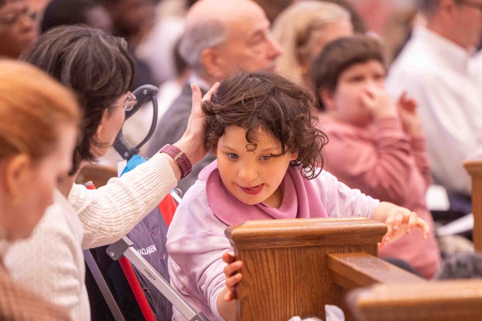 Kristi Hall sits with her daughter, Teresa, during the Archdiocese of Washington’s annual White Mass at Our Lady of Mercy Church in Potomac on Oct. 26. The liturgy celebrated the dignity and gifts of people with disabilities and their families. (Catholic Standard photo by Mihoko Owada.)