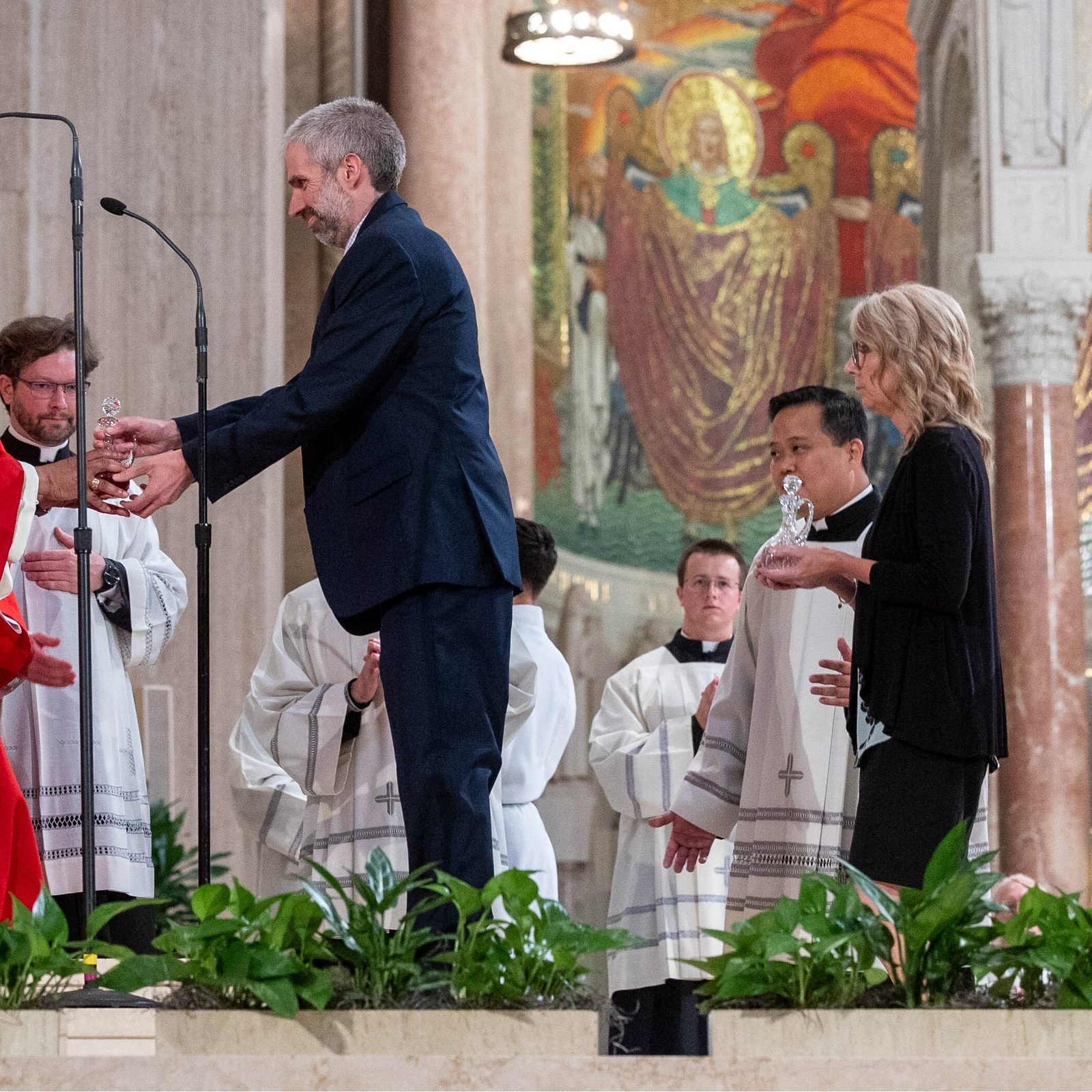 The offertory gift bearers at the Opening of Schools Mass on Aug. 26 at the National Shrine included new principals serving at Catholic schools in The Roman Catholic Archdiocese of Washington. In this photo, Cardinal Wilton Gregory receives offertory gifts from Kevin Somok from St. Jerome Academy in Hyattsville; followed by Michelle Truss from St. Philip the Apostle School in Camp Springs; Taylor Cotting from St. Raphael School in Rockville; and Dr. Anika Logan from St. Augustine Catholic School in Washington, D.C. (Catholic Standard photo by Mihoko Owada)