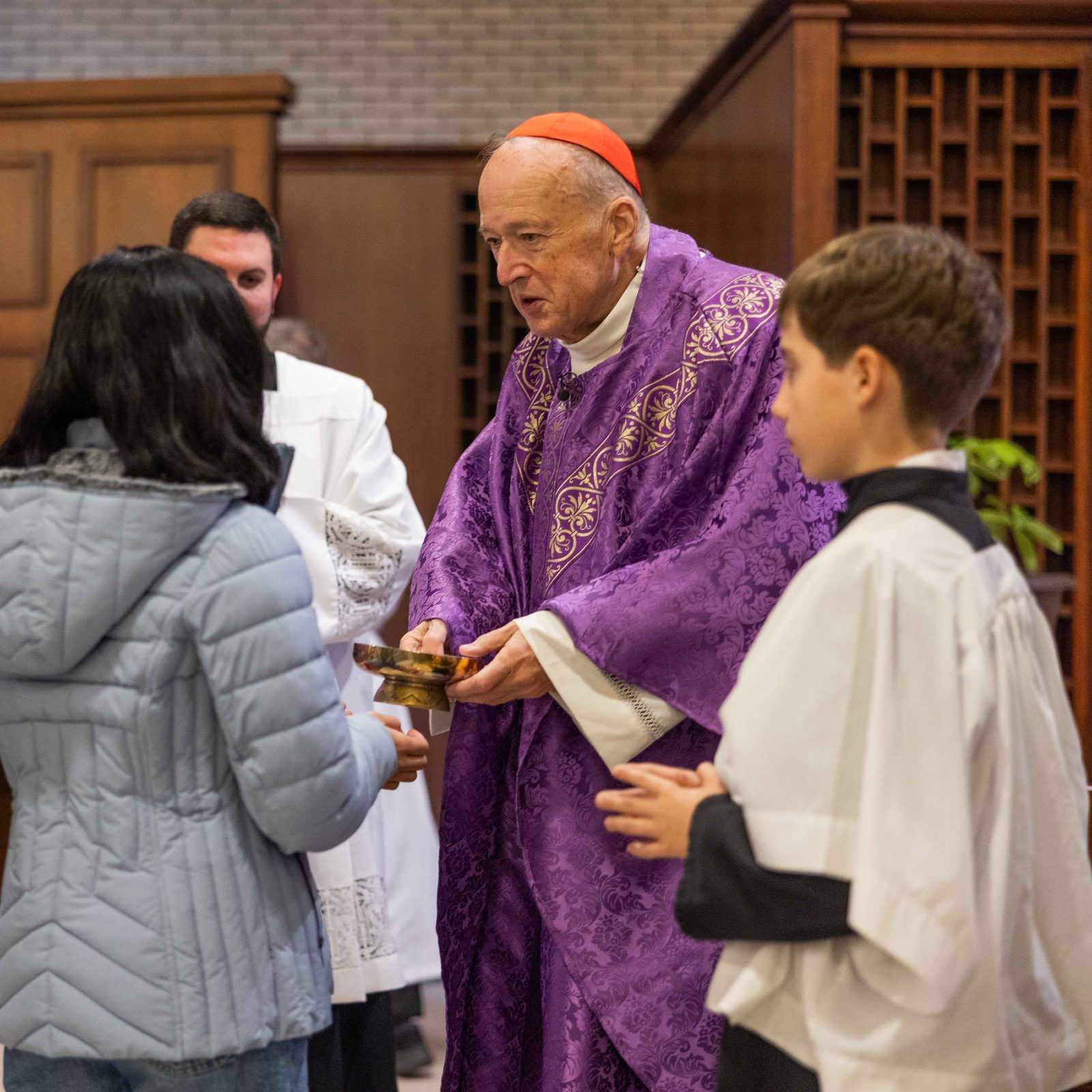 Washington Cardinal Robert W. McElroy receives the offertory gifts during a Mass on Dec. 14 at St. Hugh of Grenoble Church in Greenbelt, Maryland. (Catholic Standard photo by Andrew Biraj)