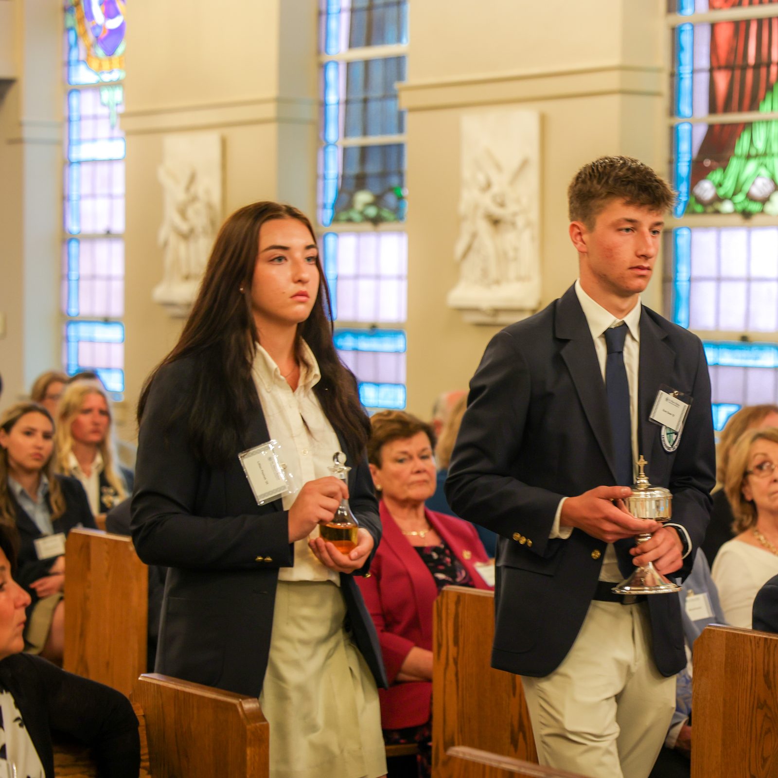 Lillian Peshek and Evan Greer of the class of 2025 at St. Mary’s Ryken High School in Leonardtown, Maryland, bring up the offertory gifts during  a June 5, 2024 Mass, where Washington Cardinal Wilton Gregory blessed the new altar at the school’s renovated Chapel of Charity. (Photo by HD Photography for St. Mary’s Ryken High School)