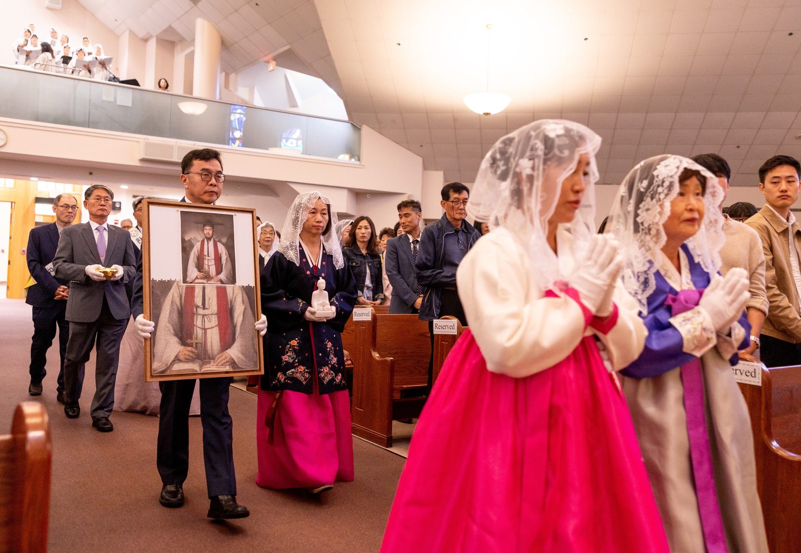 During a Mass on Sept. 29, 2024 marking the 50th anniversary of St. Andrew Kim Parish in Olney, parishioners bring offertory gifts to the altar, including a sculpture and puzzle portrait of St. Andrew Kim, the parish’s patron saint. (Catholic Standard photo by Mihoko Owada)