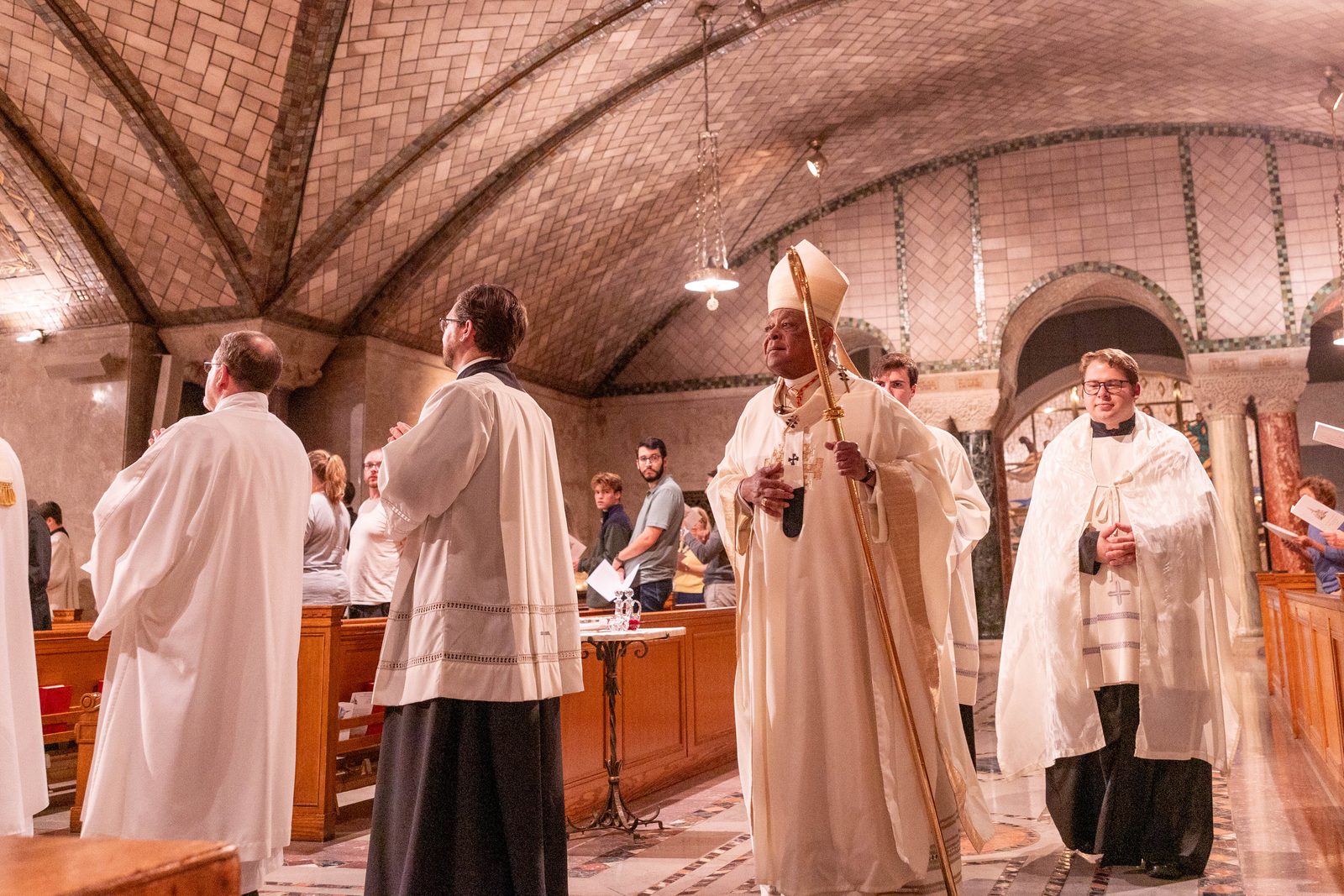 Washington Cardinal Wilton Gregory processes to the altar at the beginning of a Mass of Thanksgiving on Aug. 22, 2024 at the Crypt Church of the Basilica of the National Shrine of the Immaculate Conception that commemorated the centennial of the first priestly ordinations at the National Shrine in 1924. (Catholic Standard photo by Mihoko Owada)