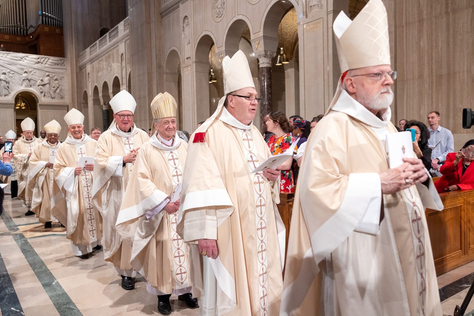 The opening procession for the Solemn Mass of Installation for Cardinal Robert McElroy as the new archbishop of Washington on March 11, 2025 at the Basilica of the National Shrine of the Immaculate Conception included eight cardinals. Seven of the participating cardinals can be seen in this photo, including from right to left, Cardinal Sean O’Malley, a Capuchin Franciscan who is the archbishop emeritus of Boston; Cardinal Joseph Tobin, a Redemptorist who is the archbishop of Newark, New Jersey; Chicago Cardinal Blase Cupich; New York Cardinal Timothy Dolan; Cardinal Donald Wuerl, an archbishop emeritus of Washington; Cardinal Wilton Gregory, an archbishop emeritus of Washington; and Cardinal McElroy. Not pictured is Cardinal Christophe Pierre, the apostolic nuncio to the United States, who at the installation read the apostolic mandate from Pope Francis appointing Cardinal McElroy as the archbishop of Washington. (Catholic Standard photo by Mihoko Owada)