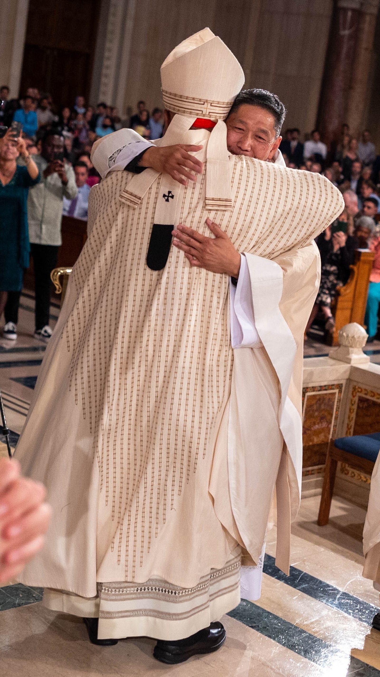 Washington Cardinal Wilton Gregory offers a sign of peace to newly ordained Father Stephen Wong during the June 15 Mass of Ordination. (Catholic Standard photo/Mihoko Owada)