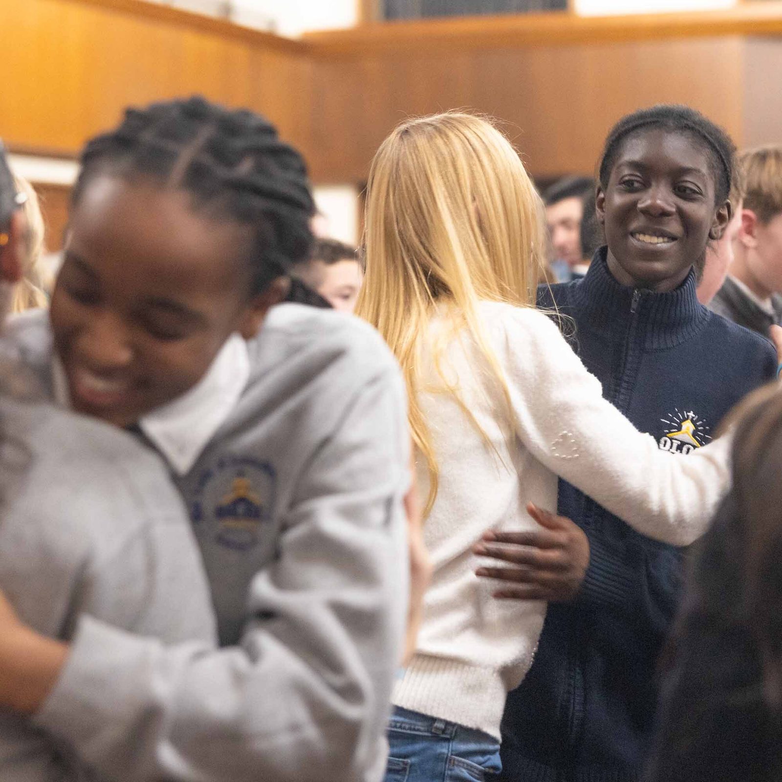 During a Feb. 11 Mass at Our Lady of Lourdes Church in Bethesda marking the parish’s 100th anniversary, students from Our Lady of Lourdes School embrace each other during the sign of peace, including Scarlett Jaramillo and Zahra Njikam, and Aspen Alber and Haliyah Meite. (Catholic Standard photo by Mihoko Owada)