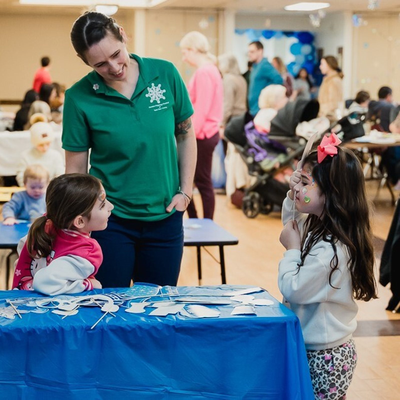 Megan DiIorio, an Explorers class teacher at Christian Beginnings Preschool, smiles with her daughter Molly and Logan McGoey, a student in the 4-year-old class, who stand at a photo booth during the Second Annual Snow Ball on Jan. 29 in Prince Frederick, Maryland. Molly a kindergartener, is a former student at the preschool. The preschool is located on the campus of St. John Vianney Parish. (Catholic Standard photo by Nicole Olea)