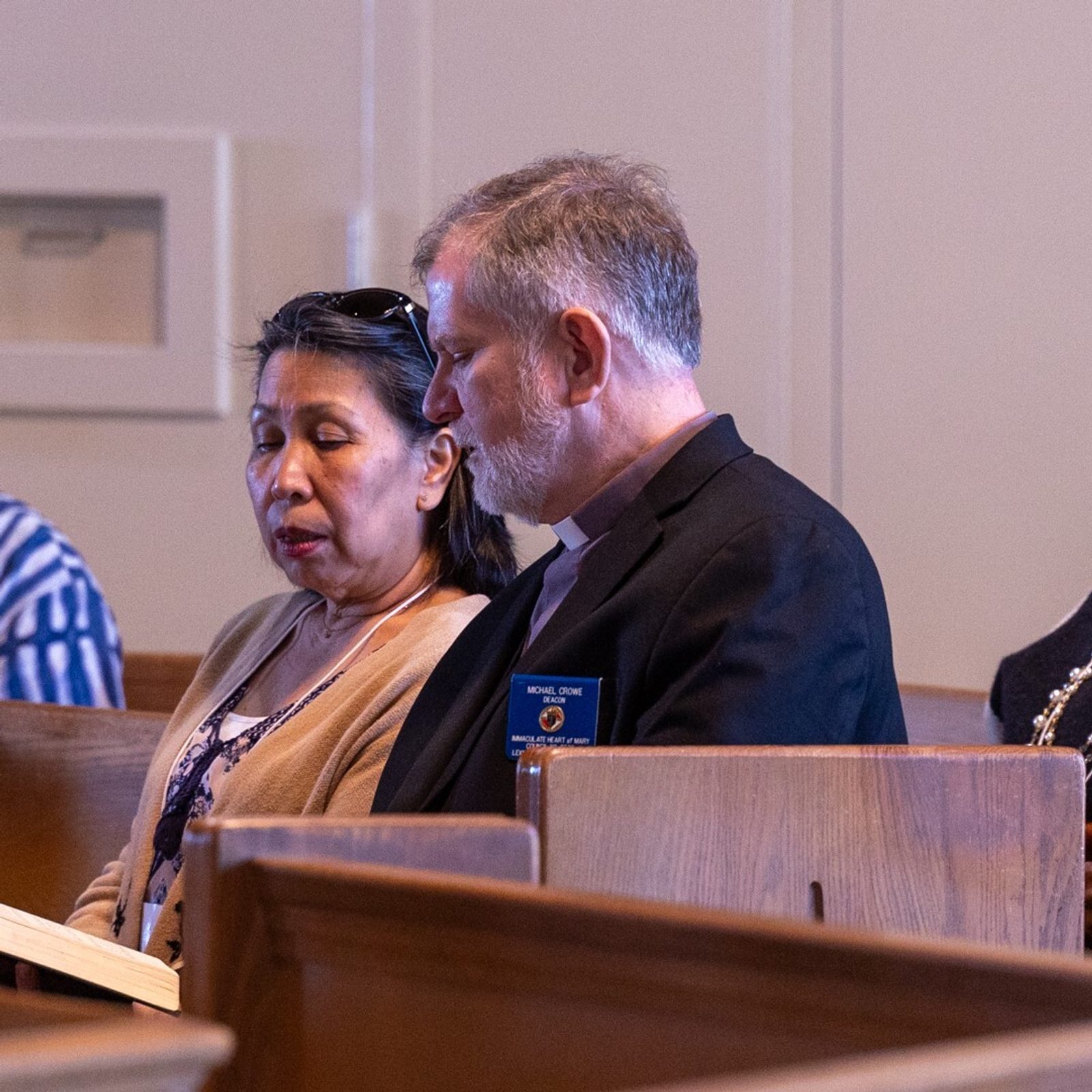 Deacon Michael Crowe and his wife Tess Crowe (at left) from Immaculate Heart of Mary Parish in Lexington Park, and Deacon Yannick Allepot (and right) and his wife Josy Allepot of St. Camillus Parish in Silver Spring attend a Mass during The Roman Catholic Archdiocese of Washington’s Annual Convocation for Permanent Deacons and Wives held at St. Joseph Church in Largo, Maryland, on Nov. 9, 2024. Deacon Allepot serves at the Basilica of the National Shrine of the Immaculate Conception and sometimes assists at Masses at his home parish. (Catholic Standard photo by Mihoko Owada)