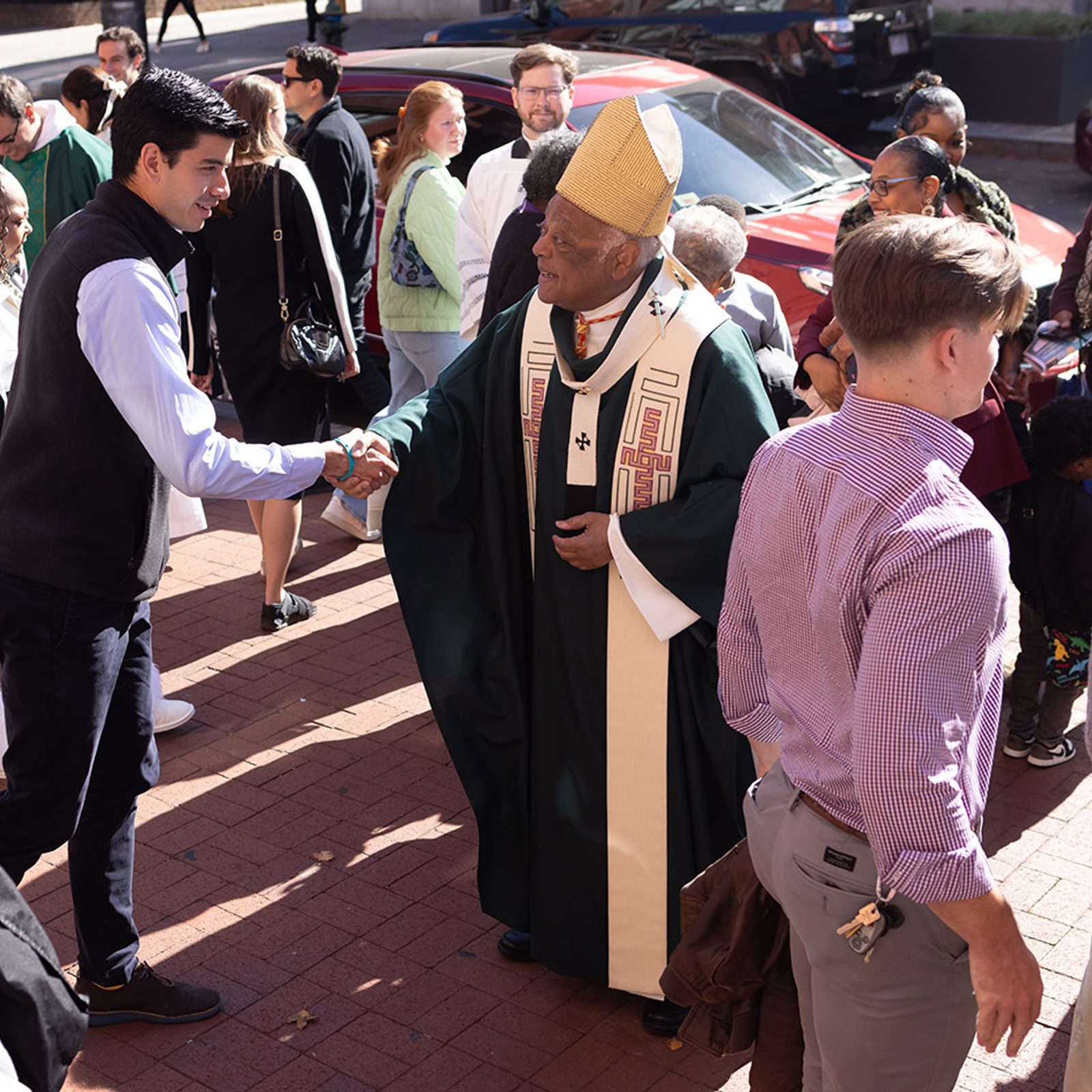 After celebrating a Mass on Nov. 3, 2024 marking the 160th anniversary of Immaculate Conception Parish in Washington, Cardinal Wilton Gregory greets people outside the church. (Catholic Standard photo by Rachel Lincoln)