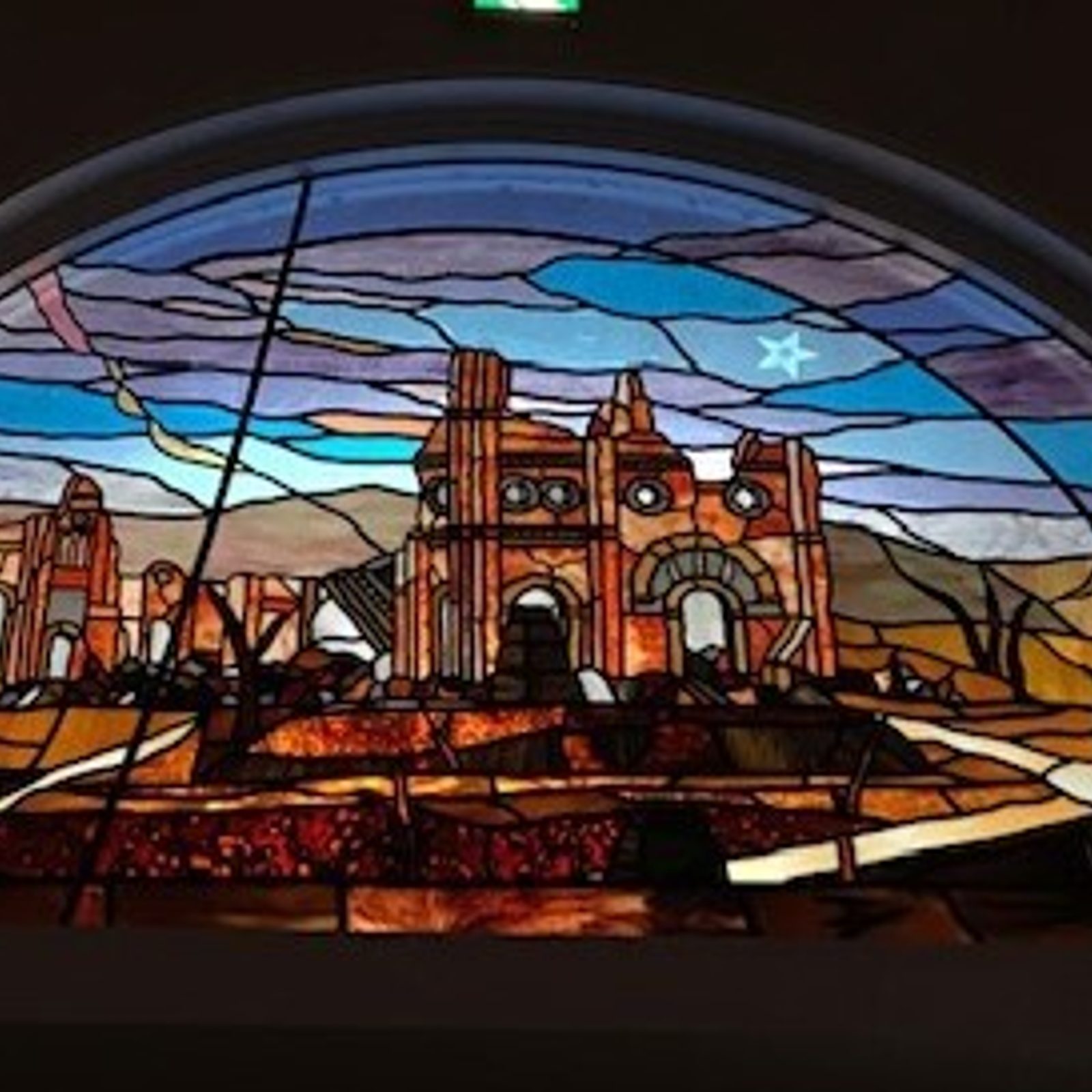 A stained glass window inside the rebuilt Urakami Cathedral in Nagasaki, Japan, shows the ruins of the cathedral there that was destroyed by the atomic bomb dropped on that city on Aug. 9, 1945. (Catholic Standard photo by Mihoko Owada)