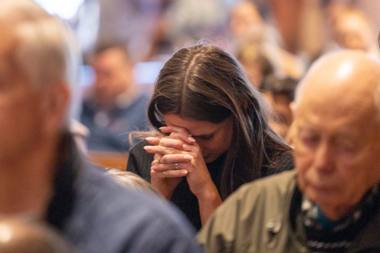 A woman prays during the Palm Sunday of the Lord’s Passion Mass celebrated by Cardinal Wilton Gregory at the Cathedral of St. Matthew the Apostle on March 24. (Catholic Standard photo by Mihoko Owada)