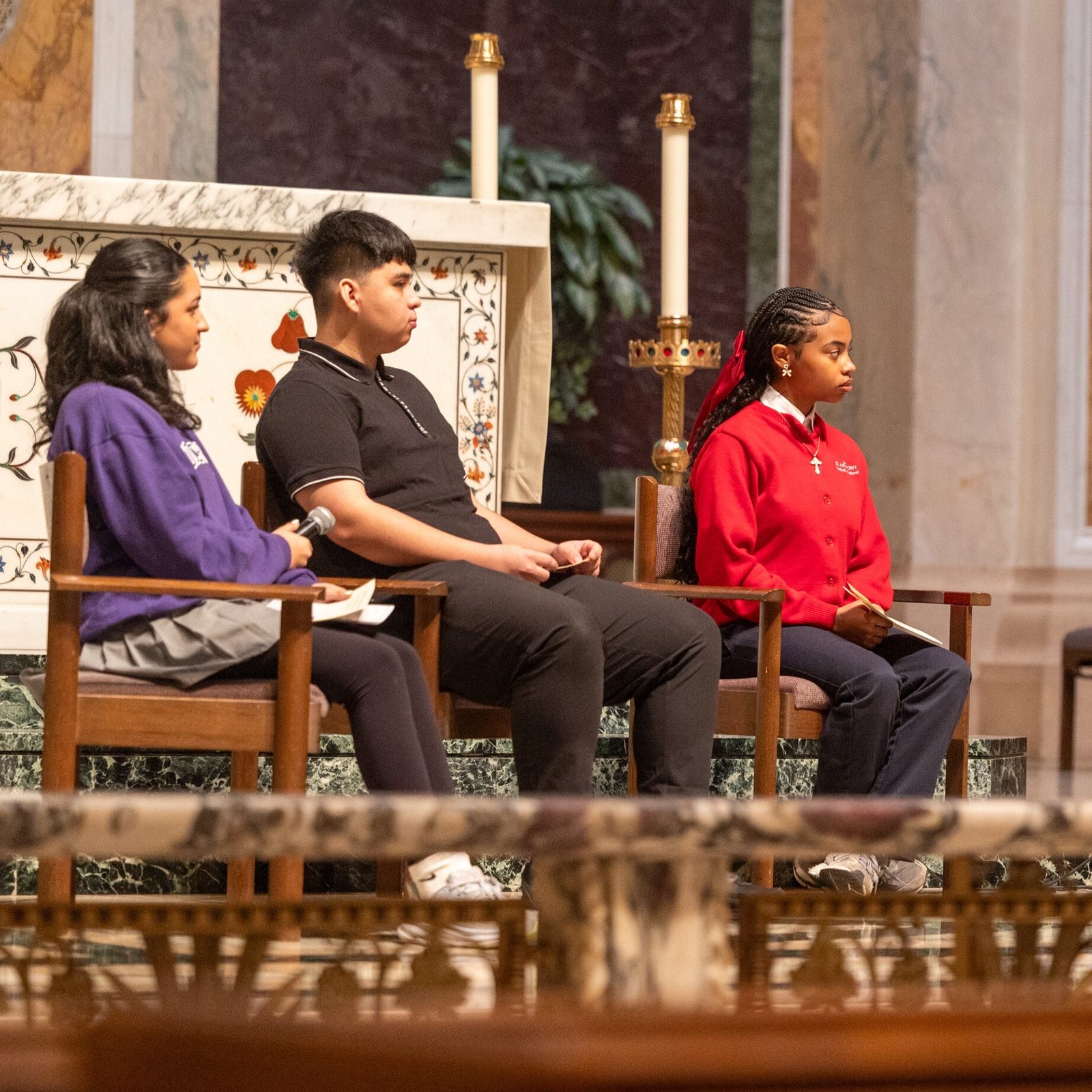 Before the Youth Mass for Life on Jan. 24, 2025 at the Cathedral of St. Matthew the Apostle in Washington, Cardinal Wilton Gregory held a question-and-answer session with youth. The students joining him were, from left to right, Andrea Patino, a 10th grader at The Academy of the Holy Cross in Kensington, Maryland; Eric Lopez, an 11th grader at Don Bosco Cristo Rey High School in Takoma Park, Maryland; and Alivia Wade, an eighth grader at St. Anthony Catholic School in Washington, D.C. (Catholic Standard photo by Mihoko Owada)